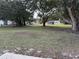 Large backyard with mature trees and grassy area at 1090 Dean St, St Cloud, FL 34771