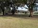 Large backyard with mature trees and swing set at 1090 Dean St, St Cloud, FL 34771