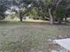 Spacious backyard with mature trees and grassy area at 1090 Dean St, St Cloud, FL 34771