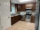 Updated kitchen featuring granite countertops and wood cabinets at 1090 Dean St, St Cloud, FL 34771