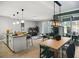 Open kitchen with island, dining area, and modern lighting at 1138 Kingsbarn St, Davenport, FL 33896