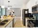 Modern kitchen with stainless steel appliances and breakfast bar at 1138 Kingsbarn St, Davenport, FL 33896