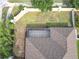 Aerial view showing house, backyard, and screened patio at 125 Viola Dr, Auburndale, FL 33823