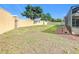Spacious backyard with grassy area and privacy wall at 125 Viola Dr, Auburndale, FL 33823
