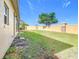 Landscaped backyard with grassy area and privacy wall at 125 Viola Dr, Auburndale, FL 33823