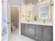 Elegant bathroom with dual vanities, marble flooring, and modern fixtures at 125 Viola Dr, Auburndale, FL 33823