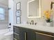 Contemporary bathroom with dark vanity and illuminated mirror at 125 Viola Dr, Auburndale, FL 33823