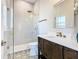 Modern bathroom with a glass shower, updated vanity, and patterned tile floor at 125 Viola Dr, Auburndale, FL 33823