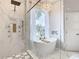 Elegant bathroom boasting a soaking tub and walk-in shower at 125 Viola Dr, Auburndale, FL 33823