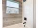 Simple bathroom with white herringbone tile and a bathtub at 125 Viola Dr, Auburndale, FL 33823