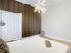 Modern bedroom with wood floors and a wood accent wall at 125 Viola Dr, Auburndale, FL 33823