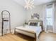 Modern bedroom with wood floors, statement wall, and stylish decor at 125 Viola Dr, Auburndale, FL 33823