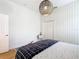 Light and airy bedroom featuring a double closet and wood flooring at 125 Viola Dr, Auburndale, FL 33823