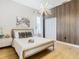 Stylish bedroom with wood floors, a statement wall, and modern lighting at 125 Viola Dr, Auburndale, FL 33823