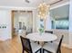 Modern breakfast nook with white quartz table and view to entry at 125 Viola Dr, Auburndale, FL 33823