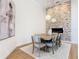 Bright dining room with stone accent wall, wood table and modern chairs at 125 Viola Dr, Auburndale, FL 33823