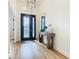 Bright entryway with hardwood floors, a console table, and a black door with glass at 125 Viola Dr, Auburndale, FL 33823
