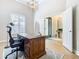Home office with large wooden desk, light walls, and hardwood floors at 125 Viola Dr, Auburndale, FL 33823
