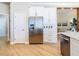 Modern kitchen with stainless steel refrigerator and white cabinetry at 125 Viola Dr, Auburndale, FL 33823