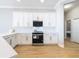 Modern kitchen with white cabinets, stainless steel appliances, and quartz counters at 125 Viola Dr, Auburndale, FL 33823