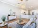 Open concept kitchen boasts white cabinets, breakfast bar, and hardwood floors at 125 Viola Dr, Auburndale, FL 33823