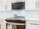 Modern kitchen with stainless steel appliances and white cabinets at 125 Viola Dr, Auburndale, FL 33823
