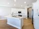 Modern kitchen with white cabinets, quartz countertops, and stainless appliances at 125 Viola Dr, Auburndale, FL 33823