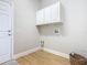 Laundry room with upper cabinets and vinyl flooring at 125 Viola Dr, Auburndale, FL 33823