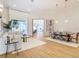 Light and airy living room with hardwood floors, and a view to dining area at 125 Viola Dr, Auburndale, FL 33823