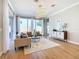 Bright living room features hardwood floors, comfy seating and large windows at 125 Viola Dr, Auburndale, FL 33823