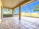 Spacious screened patio with tile flooring, overlooking a backyard at 125 Viola Dr, Auburndale, FL 33823
