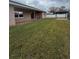 Expansive backyard featuring lush green grass, privacy fence, covered patio, and gazebo at 149 Birmingham Dr, Kissimmee, FL 34758