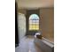Bright bathroom featuring a soaking tub, tiled floors, and a large arched window at 149 Birmingham Dr, Kissimmee, FL 34758