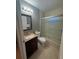 Clean bathroom with a single vanity, toilet and shower/tub combo at 149 Birmingham Dr, Kissimmee, FL 34758
