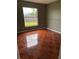 Bedroom boasts a large window overlooking the green yard and decorative patterned tile flooring at 149 Birmingham Dr, Kissimmee, FL 34758