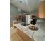 Well-lit kitchen with marbled countertops, stainless steel appliances, and ample cabinet space at 149 Birmingham Dr, Kissimmee, FL 34758