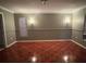 Spacious living room featuring unique tile flooring and natural lighting from two windows at 149 Birmingham Dr, Kissimmee, FL 34758