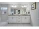 Double vanity bathroom with granite countertops and large mirror at 203 North Cir, Davenport, FL 33837