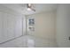 Bright bedroom featuring double door closet and tile flooring at 203 North Cir, Davenport, FL 33837