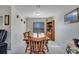 Bright dining room with wooden table and view of kitchen at 203 North Cir, Davenport, FL 33837