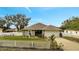 Cute one-story house with a white picket fence and a well-manicured lawn at 203 North Cir, Davenport, FL 33837