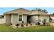 One-story house with nicely landscaped front yard and a white fence at 203 North Cir, Davenport, FL 33837