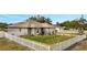 Charming house with a white picket fence and solar panels on the roof at 203 North Cir, Davenport, FL 33837