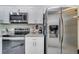 Modern kitchen boasts stainless steel appliances and granite countertops at 203 North Cir, Davenport, FL 33837
