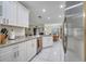 Open concept kitchen with stainless steel appliances and granite countertops at 203 North Cir, Davenport, FL 33837