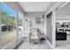 Relaxing screened porch with patio furniture and access to backyard at 203 North Cir, Davenport, FL 33837