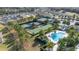 Aerial view of community with pool, tennis, bocce, and homes at 2051 Flora Pass Pl, Kissimmee, FL 34747