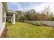 Landscaped backyard with grassy lawn and privacy fence at 2051 Flora Pass Pl, Kissimmee, FL 34747