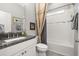 Clean bathroom with granite countertop, white vanity, and shower/tub combo at 2051 Flora Pass Pl, Kissimmee, FL 34747