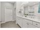 Elegant bathroom with double vanity, large mirror, and a walk-in shower at 2051 Flora Pass Pl, Kissimmee, FL 34747